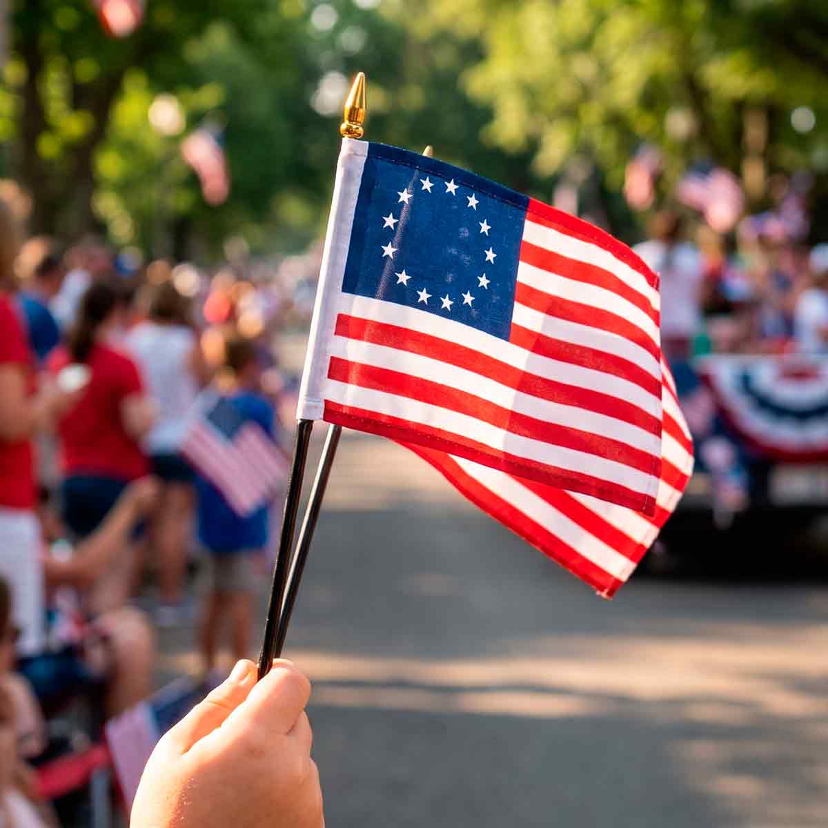Betsy Ross hand flag waved at a Fourth of July parade