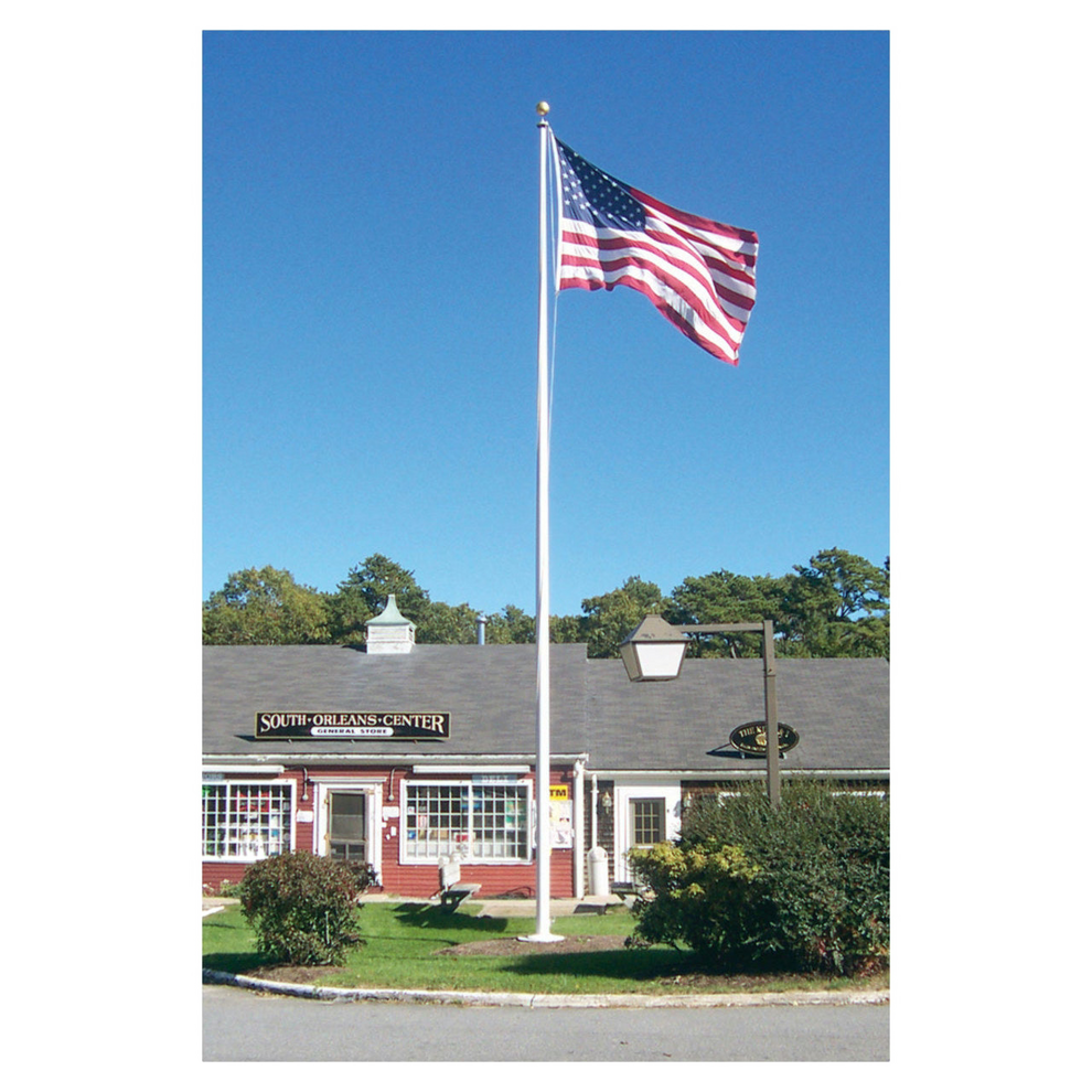 Building with an American flag on a flagpole against a clear blue sky