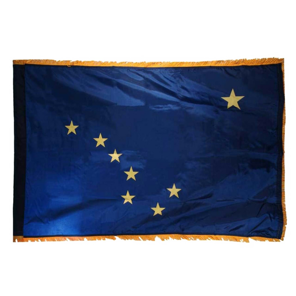Alaska state flag with a blue background and yellow stars with yellow fringe on edges