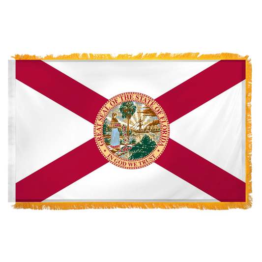 State of Florida flag featuring the classic red diagonal cross on a white background with the full-color Florida state seal in the center. The words 'GREAT SEAL OF THE STATE OF FLORIDA' and 'IN GOD WE TRUST' are written on the edges of the seal. This flag features yellow fringe.
