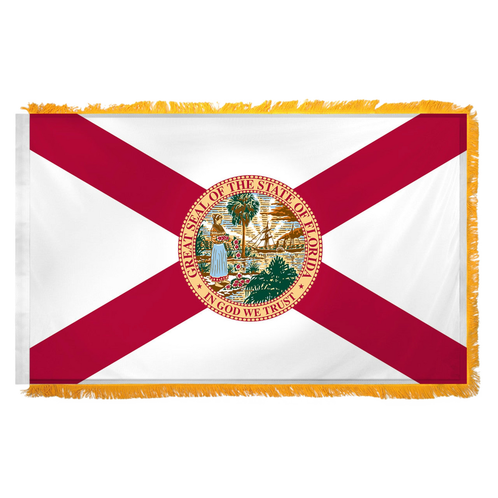 State of Florida flag featuring the classic red diagonal cross on a white background with the full-color Florida state seal in the center. The words 'GREAT SEAL OF THE STATE OF FLORIDA' and 'IN GOD WE TRUST' are written on the edges of the seal. This flag features yellow fringe.