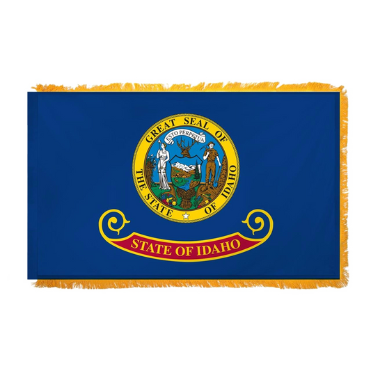 State of Idaho flag featuring the full-color state seal with the text 'ESTO PERPETUA' on a blue background with the 'State of Idaho' red and gold banner. This flag features yellow fringe.