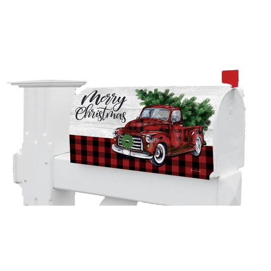 White mailbox with a Christmas design featuring a red truck and tree, and 'Merry Christmas' text.
