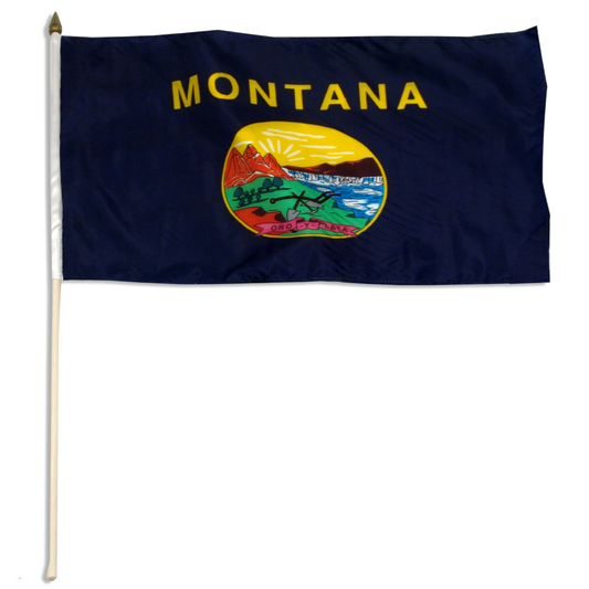 State of Montana stick flag with 'MONTANA' printed in large, gold all-caps letters across the top. Centered below the text is the full-color state seal, depicting a landscape with the Rocky Mountains, the Great Falls of the Missouri River, a plow, a shovel, and a pick. A ribbon at the bottom of the seal reads the Spanish motto 'ORO Y PLATA'.