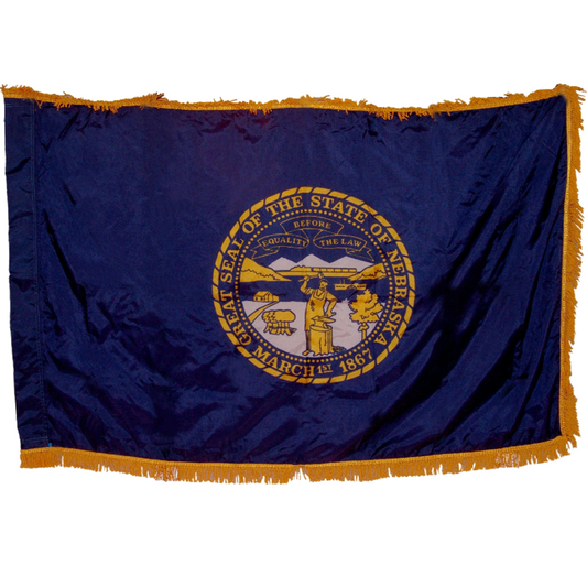 State of Nebraska state flag featuring the gold and silver state seal with the motto 'Equality Before the Law' on a solid dark blue field. Seal includes a steamboat on a river, a train moving across mountains, a blacksmith at work, and a settler's cabin. This flag features yellow fringe.