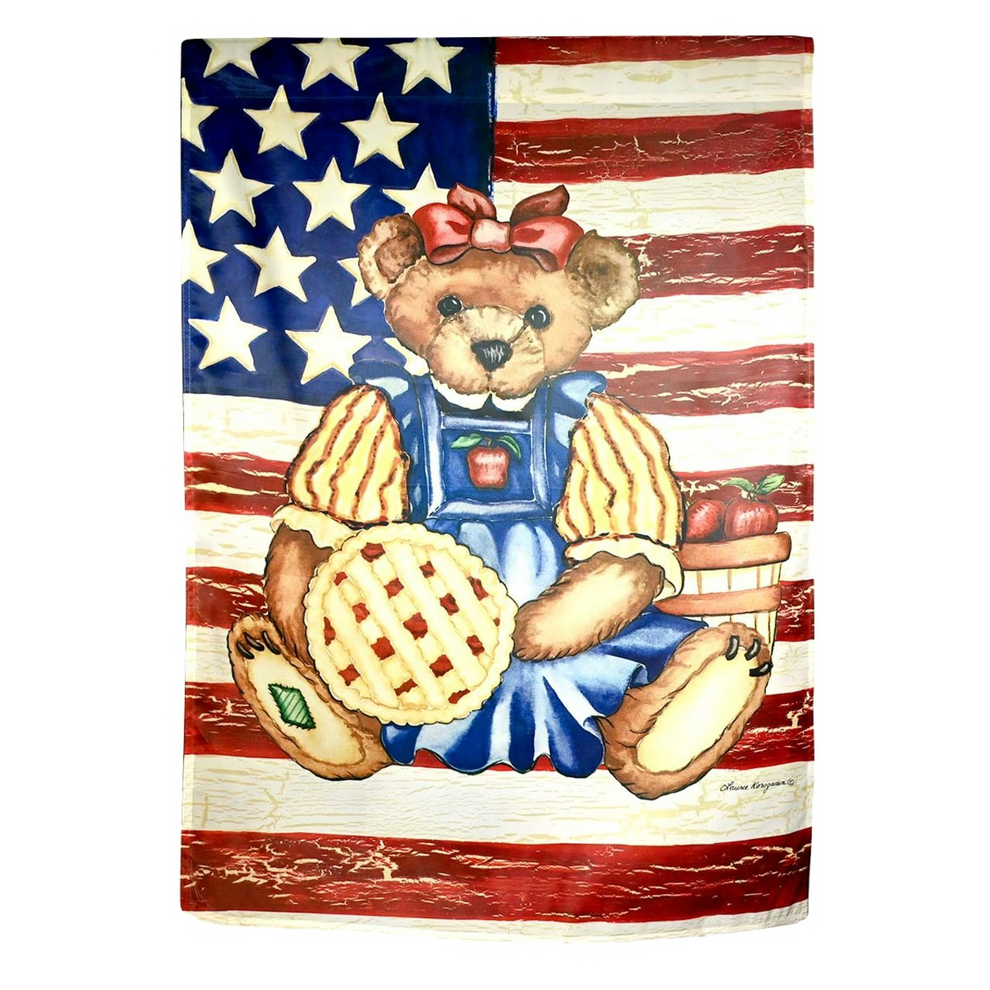 Decorative flag with a bear in overalls holding a pie with an American flag background