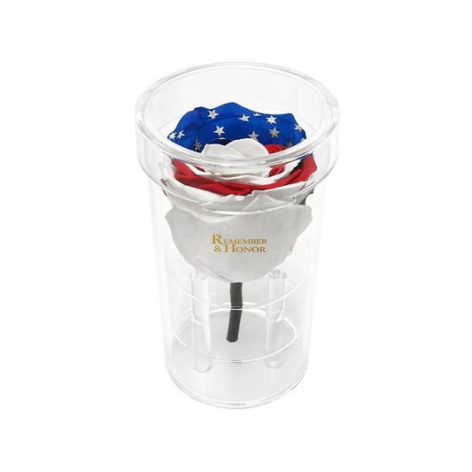 Clear plastic cup with patriotic-themed items inside on a white background