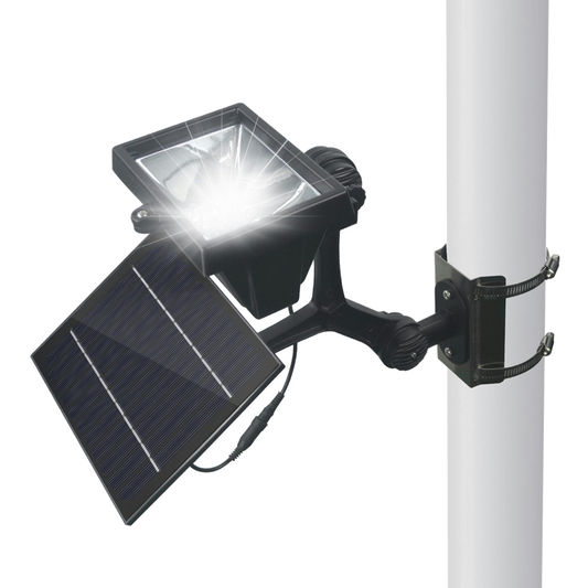 Close up of a solar powered LED flagpole light on a white background.