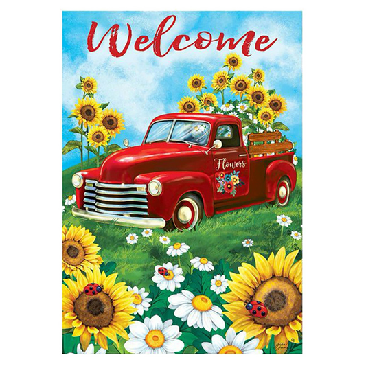 Decorative flag with a red truck with sunflowers and flowers in a field, featuring the word 'Welcome'.