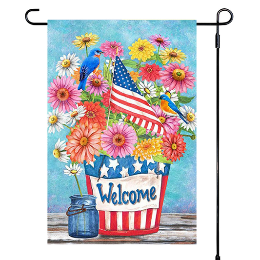 Decorative garden flag with flowers, birds, and an American flag on a blue background.