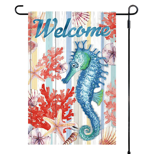 Decorative garden flag with a seahorse, coral, and starfish design on a striped background with the word 'Welcome'.