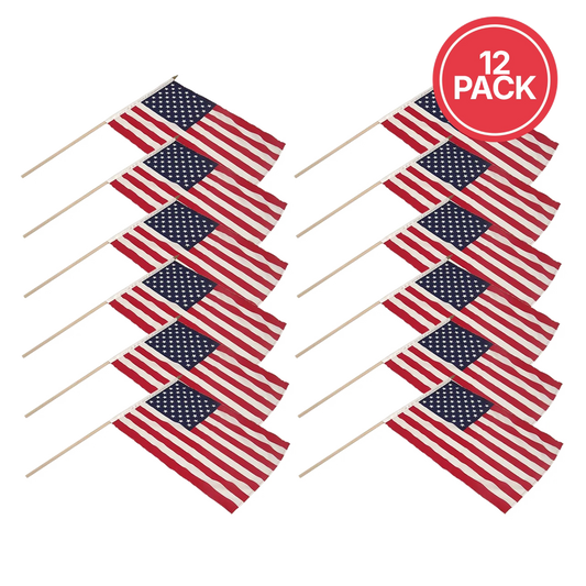 Twelve small American flags on wooden sticks, arranged in two rows of six on a white background, with a red circular badge in the top right that reads '12 PACK'.