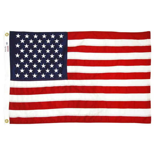 An American flag with 50 stars and 13 red and white stripes, shown flat against a plain white background. The flag has brass grommets on the left white header.