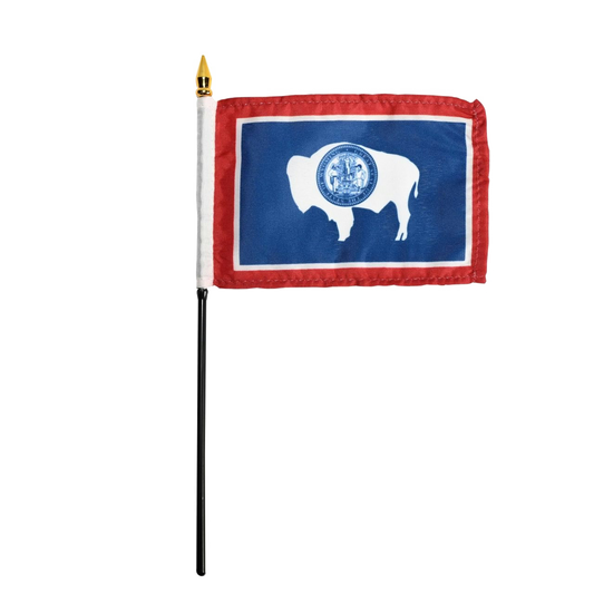 Small Wyoming state stick flag with a blue background and white silhouette of a bison, on a white background