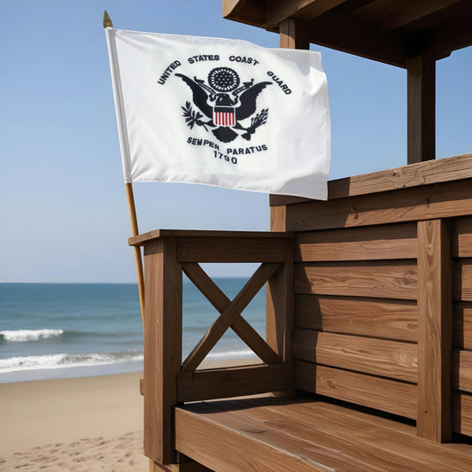 US Coast Guard 12 US Coast Guard flag on a wooden structure by the beach.