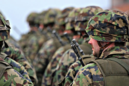 Group of soldiers in camouflage uniforms standing in formation.