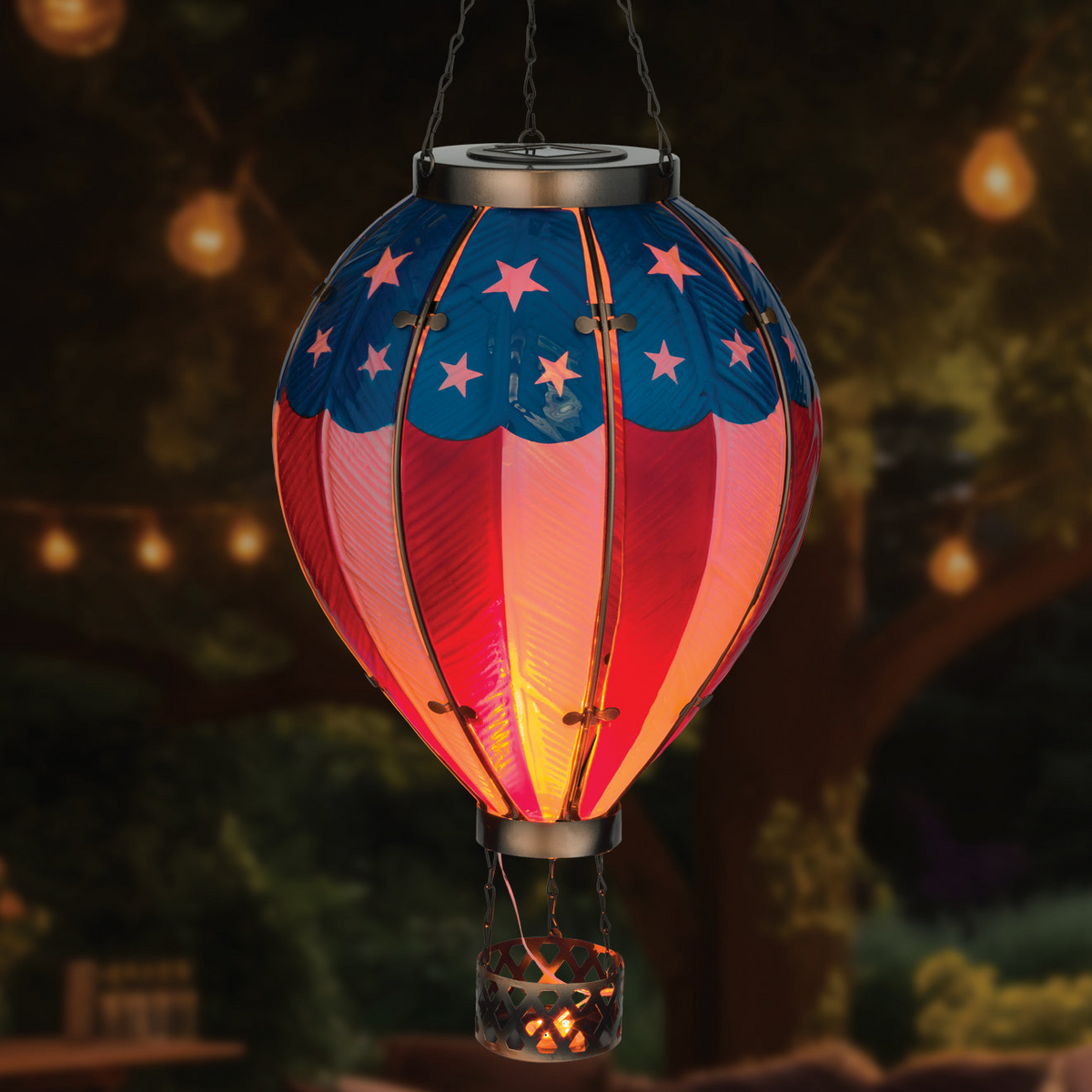 Decorative lantern shaped like a hot air balloon with American flag design, glowing in the dark.