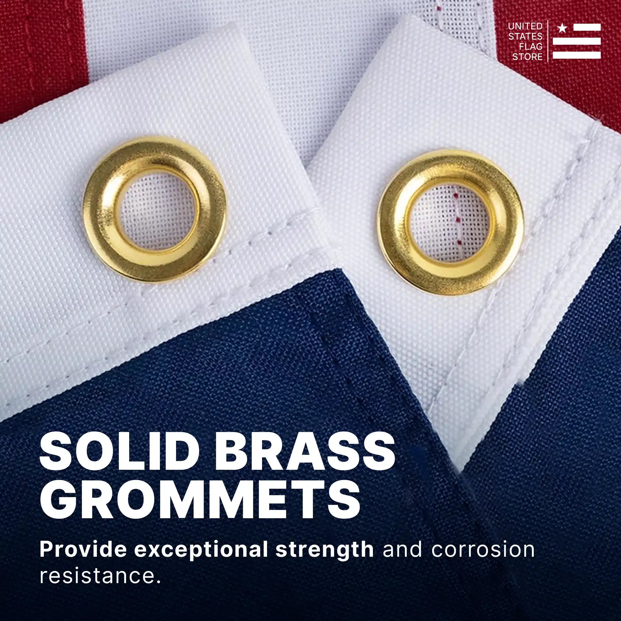 Two solid brass grommets on a white flag header providing strength and corrosion resistance for outdoor hanging.