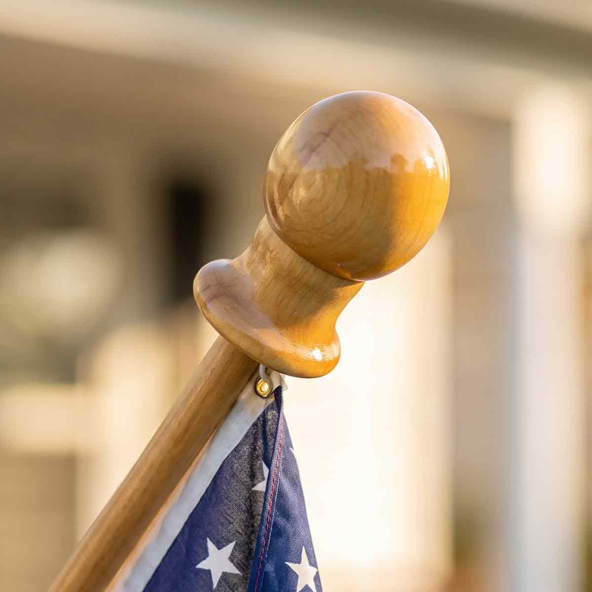 Classic wooden flagpole displaying an American flag