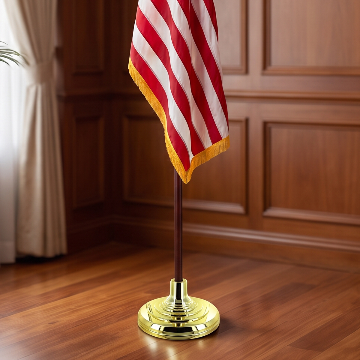 Indoor flagpole set featuring a gold base, wooden pole, and fringed flag