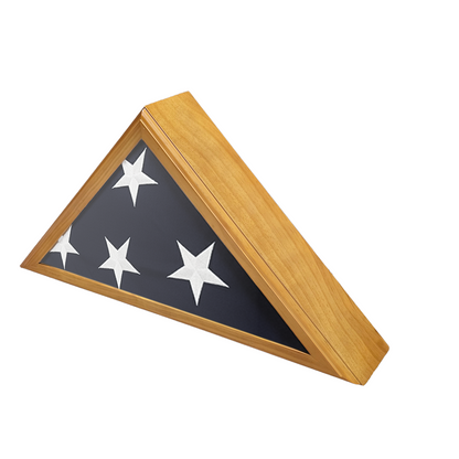 A triangular flag display case with a wooden frame on a white background featuring.  The flag is folded showing four white stars and the blue canton