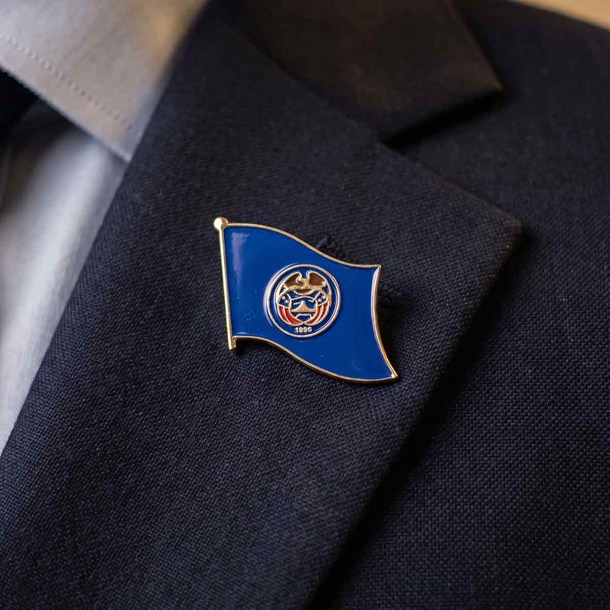 state flag lapel pin on a suit jacket