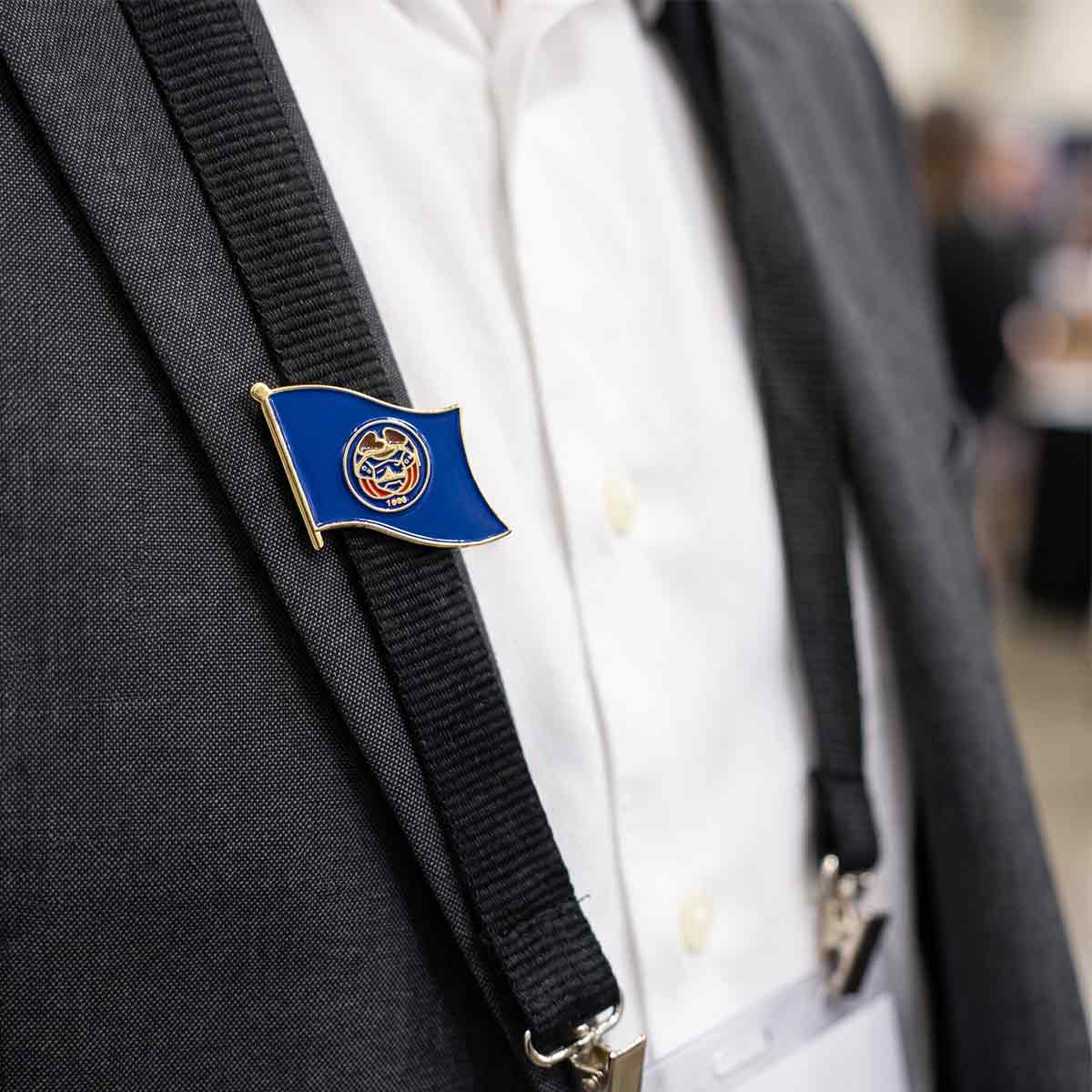 state flag lapel pin on a suit jacket with suspenders