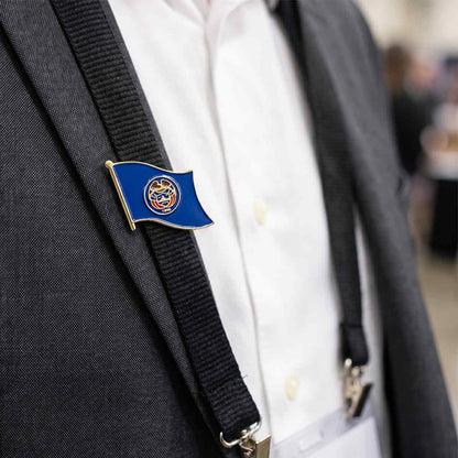 state flag lapel pin on a suit jacket with suspenders