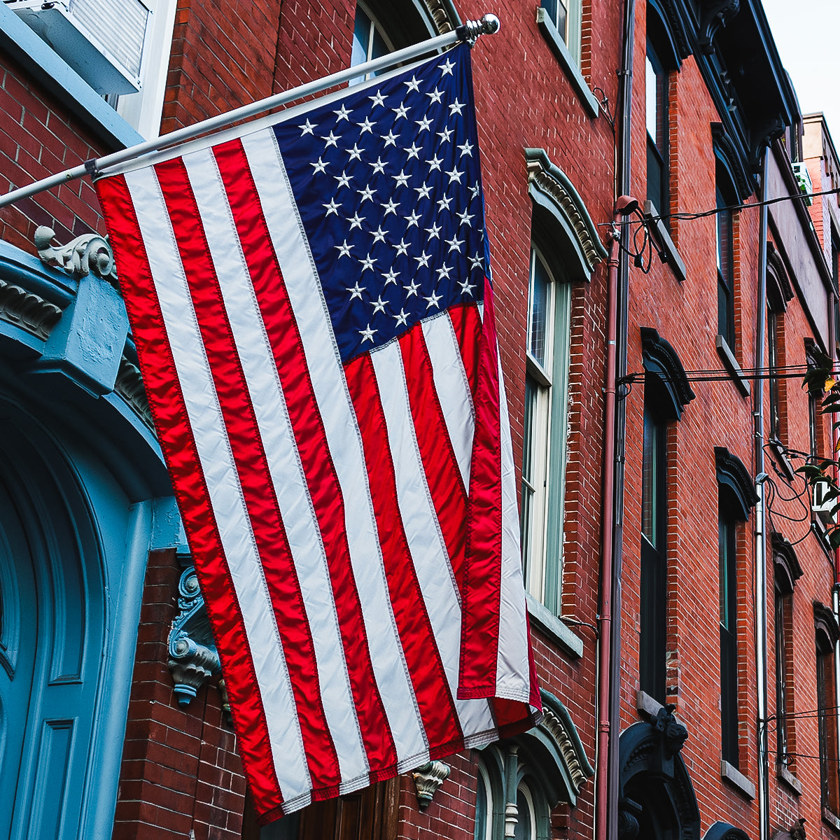 American flag hanging on a brick building