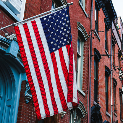 American flag hanging on a brick building