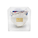 White socks with gold text in a clear cube packaging on a white background