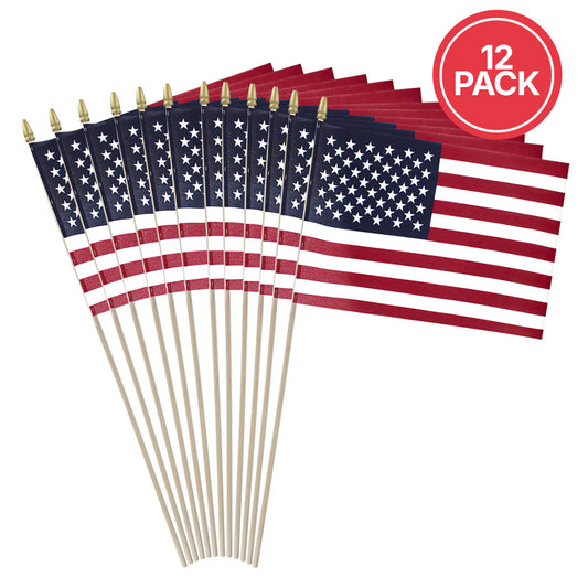 A 12-pack of small American flag stick flags with wooden sticks and gold spear tips, arranged in a fan shape on a white background with a red circular '12 PACK' badge in the top right.