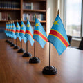Black desk flag stands with gold spear toppers displaying Congo flags