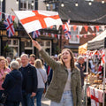 England flag waved by a woman at a street celebration