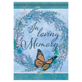 Memorial banner with 'In loving memory' text, butterfly, and floral wreath on a blue background.