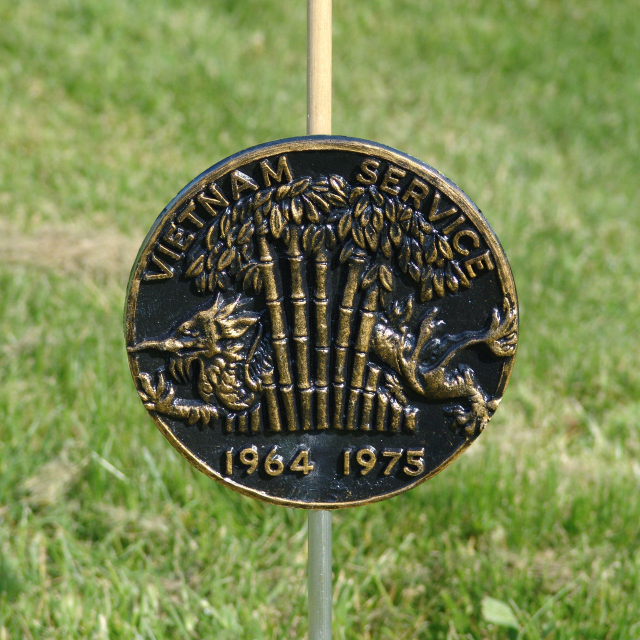 Bronze Vietnam Service medal on a stick with a grassy background