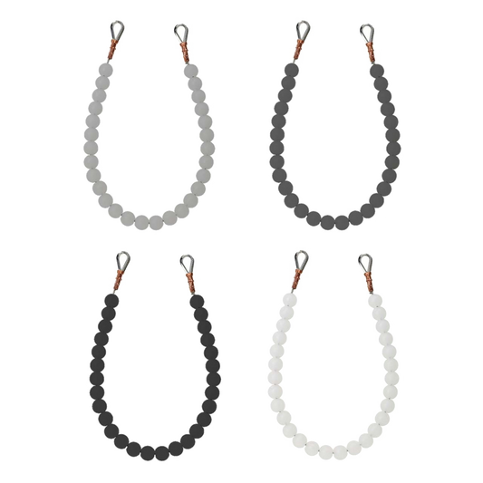 Four beaded retainer rings of different colors on a white background