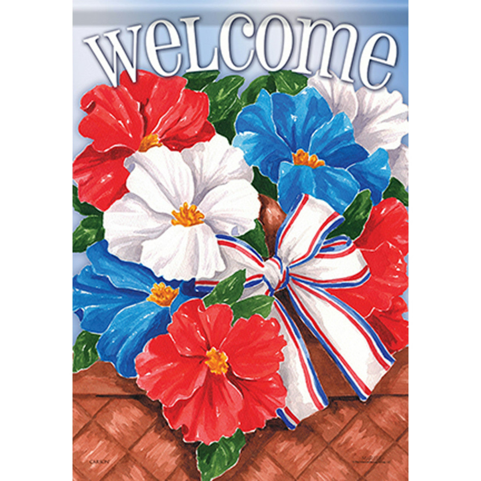 Decorative flag with red, white, and blue flowers and a bow on a wooden surface.