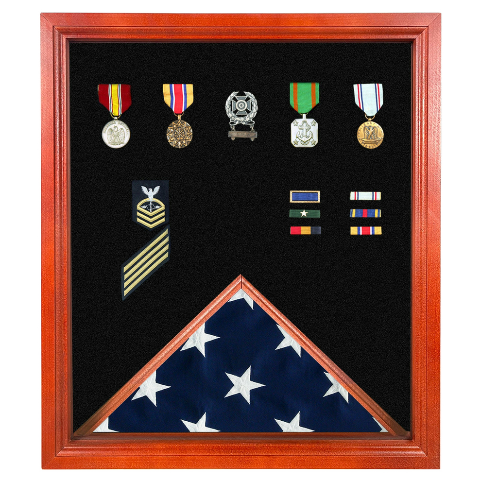 Framed military shadow box displaying medals, ribbons, rank insignia, and a folded American flag.
