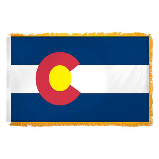 State of Colorado flag featuring the iconic blue and white horizontal stripes with the red 'C' and golden yellow disk design.  This flag features yellow fringe.