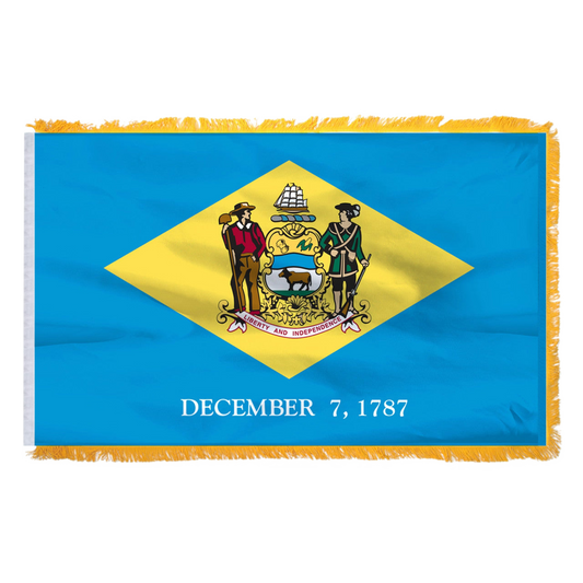 Delaware state flag with a yellow and blue design featuring a coat of arms and 'December 7, 1787' text on a white background.
