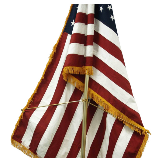 American flag with gold fringe on a white background
