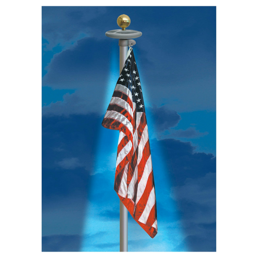 American flag on a flagpole against a blue sky with clouds and a flagpole light shining down on the flag