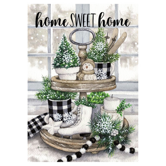Decorative flag with two-tiered wooden stand with decorative items including a snowman, trees, and checkered fabric against a window background.