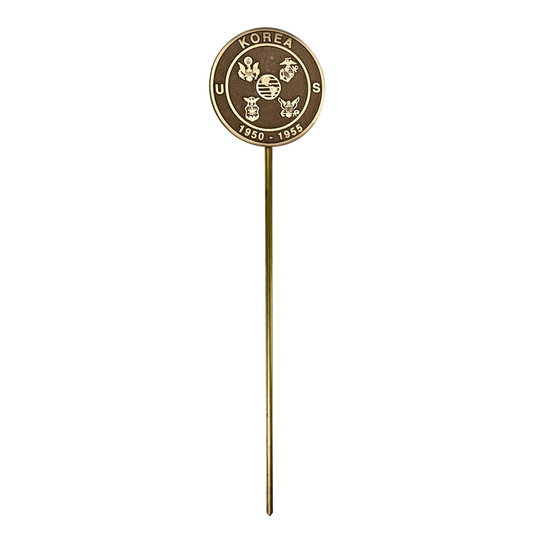 A grave marker with a circular emblem featuring text and symbols on a white background