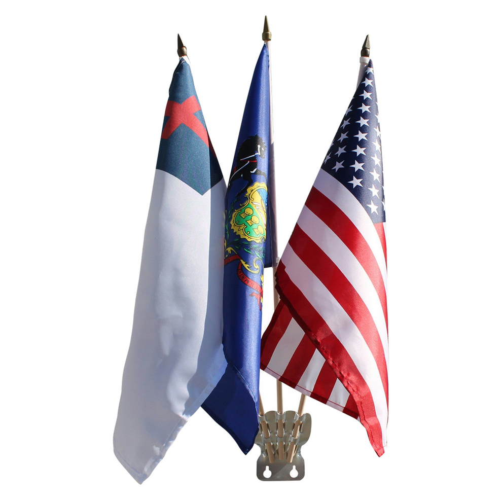 Three small flags on a stand: a blue and white flag, a blue state flag with an emblem, and the American flag.