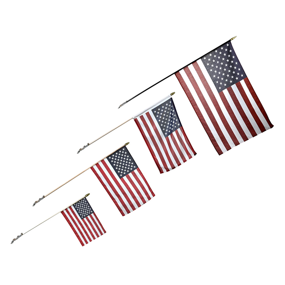 Four American flags on sticks arranged diagonally by size, from largest to smallest.