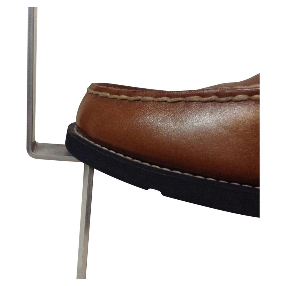 Shoe pushing down on a stake from a grave marker