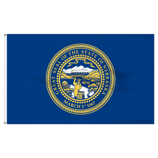 State of Nebraska state flag featuring the gold and silver state seal with the motto 'Equality Before the Law' on a solid dark blue field.  Seal includes a steamboat on a river, a train moving across mountains, a blacksmith at work, and a settler's cabin.