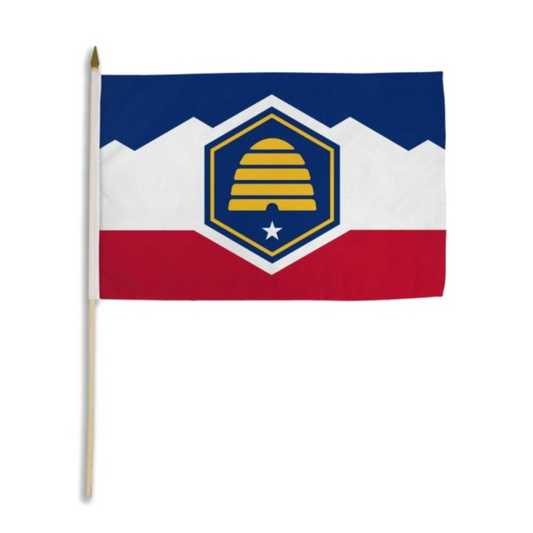 Utah state flag with blue and red halves and a white mountain range in the middle with a blue hexagon with a yellow beehive and white star